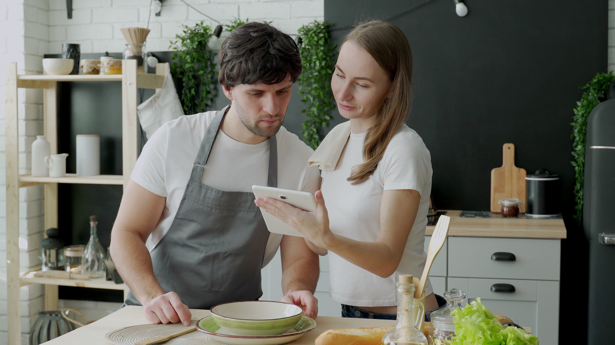 chef advising home cook in kitchen